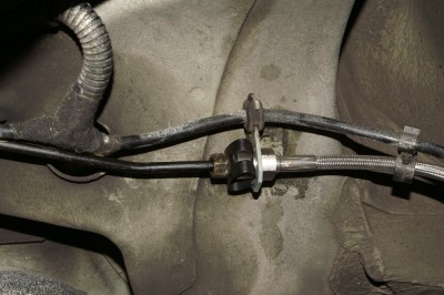 Braided Line Fitting on Underbody to OE Brake Pipe through Original Bracket on Vehicle. No Modification Required.